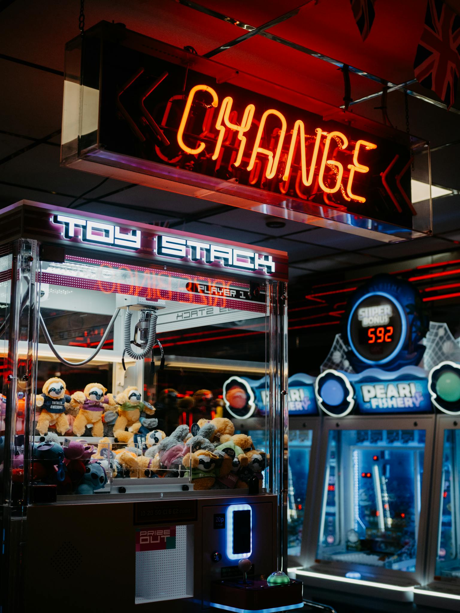 Engaging arcade scene featuring neon lights, claw machines, and a bustling atmosphere.